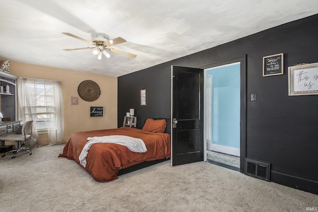 carpeted bedroom with visible vents and a ceiling fan