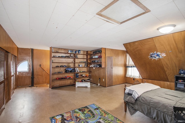 bedroom featuring wood walls and tile patterned floors