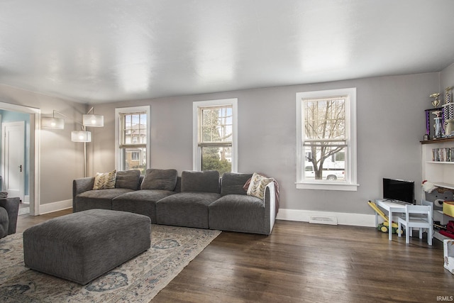 living room with dark wood finished floors and baseboards