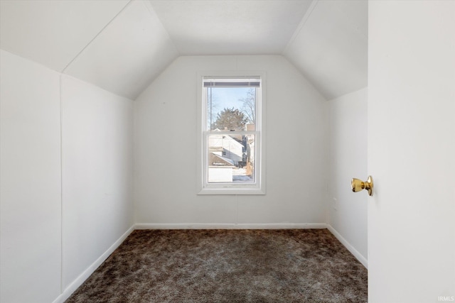 bonus room with carpet floors, baseboards, and vaulted ceiling