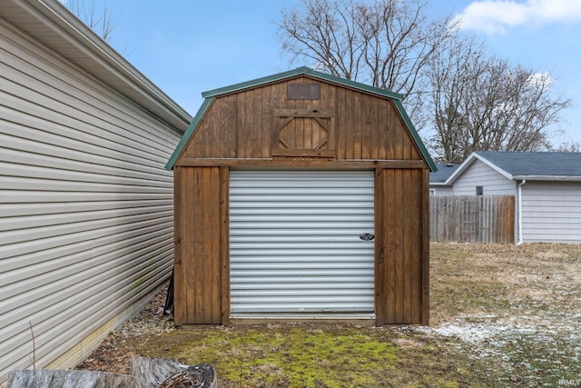 view of shed featuring fence