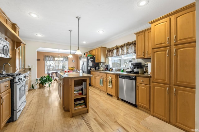 kitchen featuring open shelves, stainless steel appliances, ornamental molding, light wood-style floors, and a sink