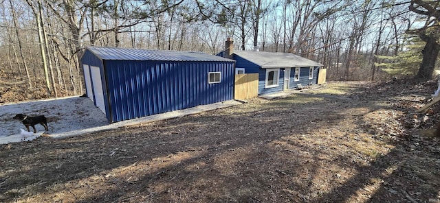 exterior space with an outbuilding and metal roof