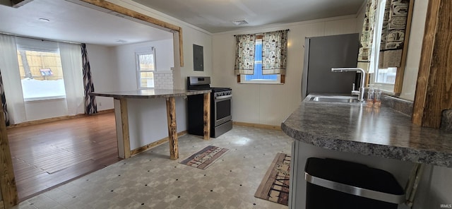 kitchen with a sink, visible vents, electric panel, stainless steel gas stove, and dark countertops