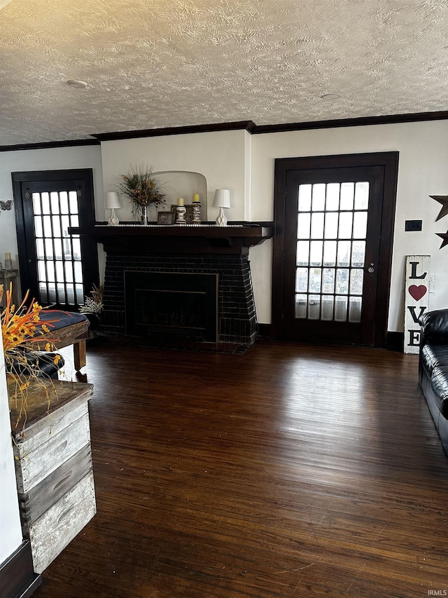 living room featuring crown molding, a fireplace, and wood finished floors