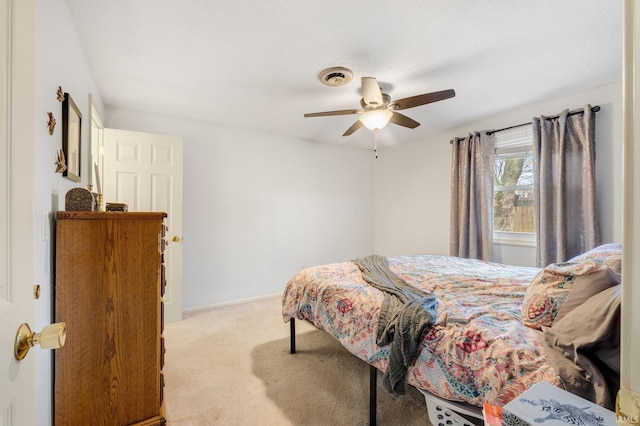 bedroom with baseboards, visible vents, a ceiling fan, and light colored carpet