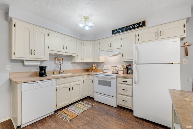 kitchen featuring dark wood-type flooring, a sink, a textured ceiling, white appliances, and under cabinet range hood