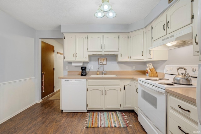 kitchen featuring dark wood-style flooring, light countertops, a sink, white appliances, and under cabinet range hood