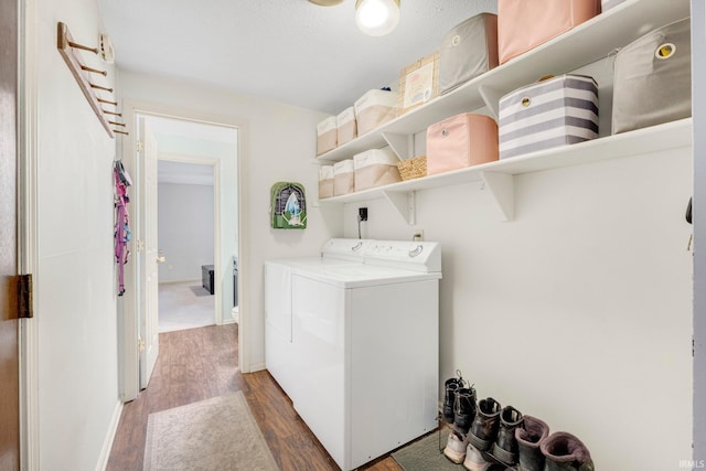 washroom featuring laundry area, wood finished floors, and washer and dryer