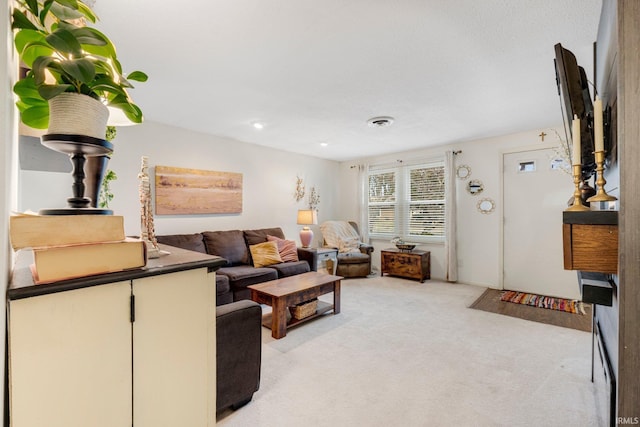 living room with visible vents and light colored carpet