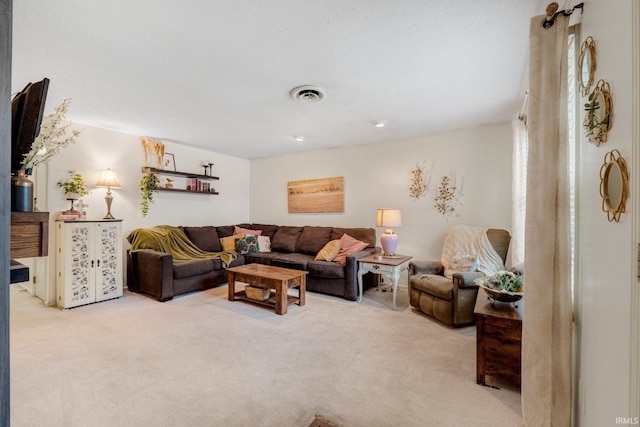 living room with visible vents and light colored carpet