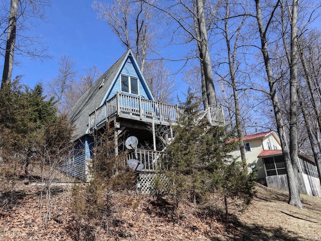 view of front of home with a wooden deck and stairs