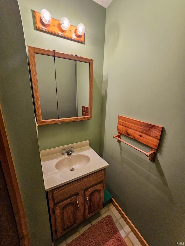 bathroom featuring baseboards and vanity