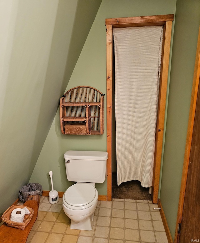 bathroom featuring baseboards, toilet, and tile patterned floors