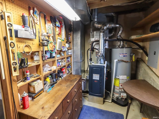 utility room with electric panel and water heater