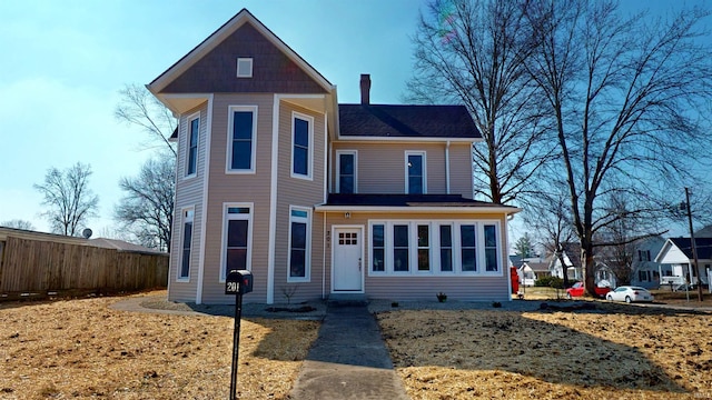 view of front of house featuring fence