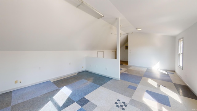 additional living space featuring ceiling fan, baseboards, and vaulted ceiling