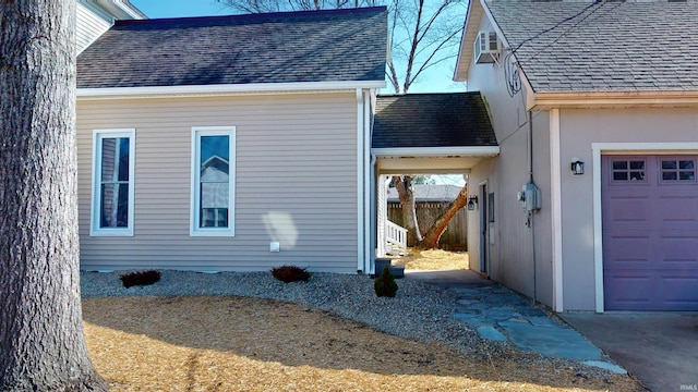 view of home's exterior with a shingled roof