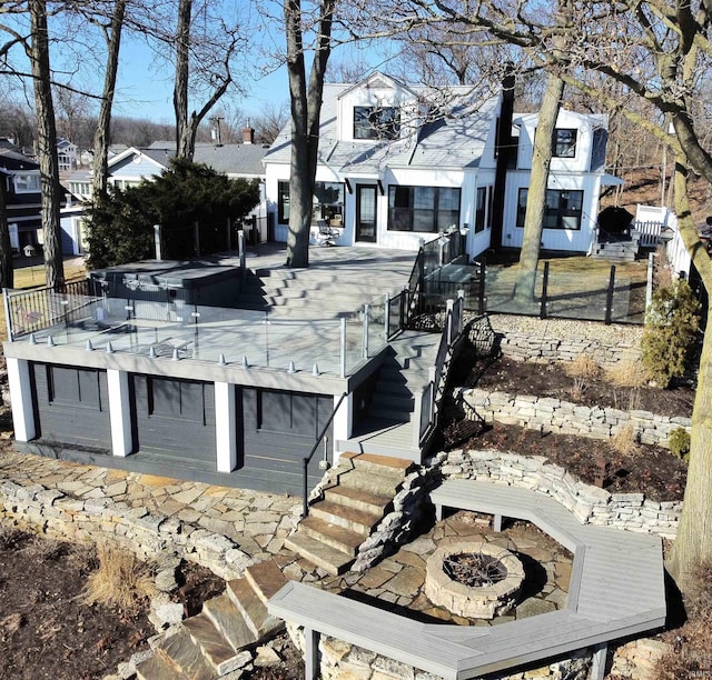 exterior space with a residential view, fence, and an outdoor fire pit