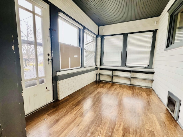 unfurnished sunroom with wood ceiling and visible vents