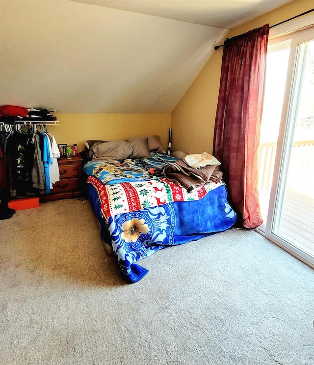 bedroom featuring carpet floors, access to outside, and vaulted ceiling