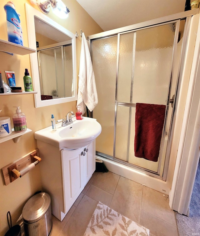 full bath featuring a stall shower, vanity, and tile patterned floors