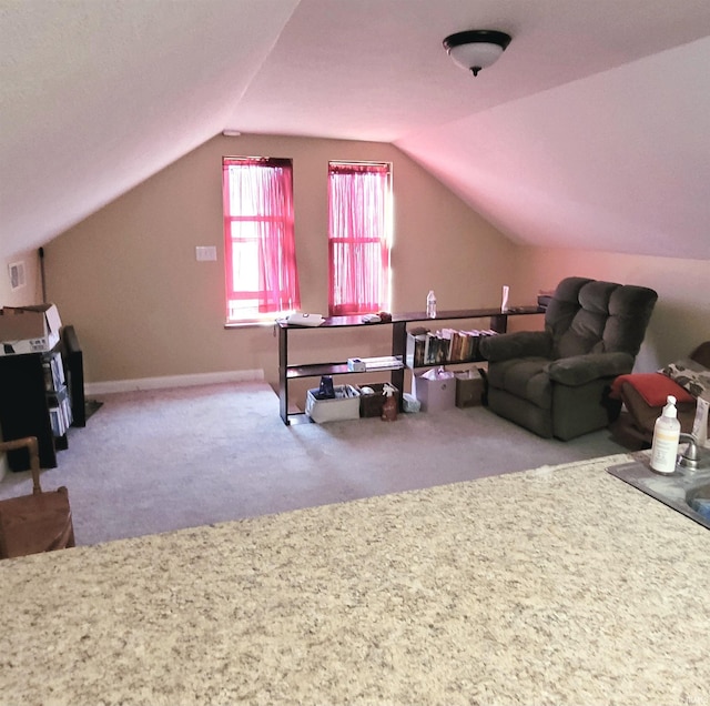 interior space with lofted ceiling, carpet, and baseboards