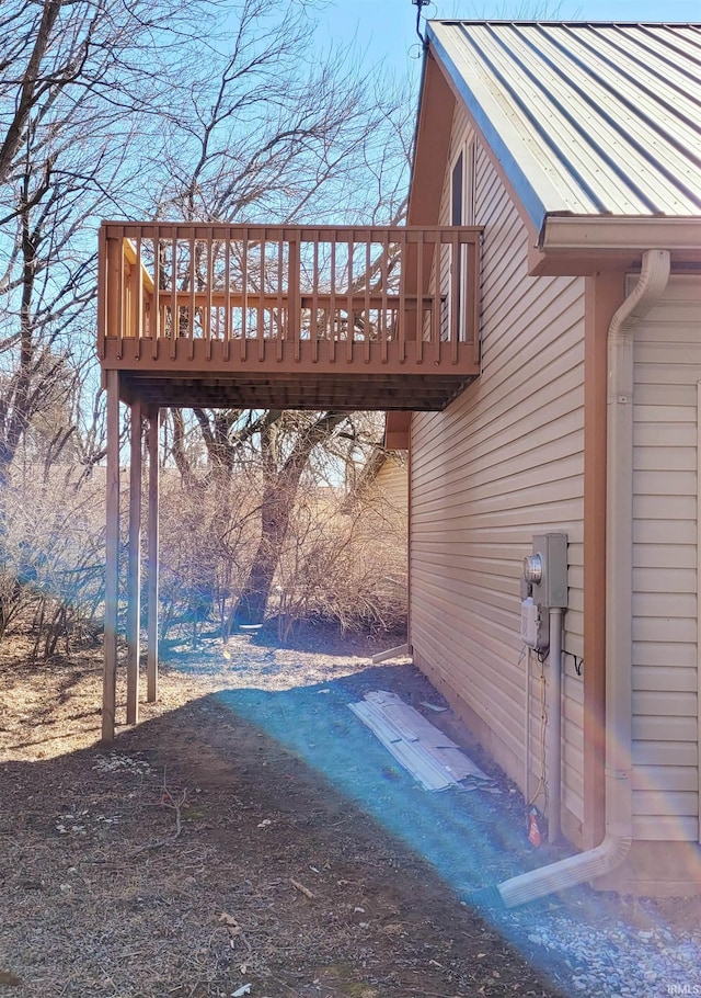 exterior space featuring metal roof and a wooden deck