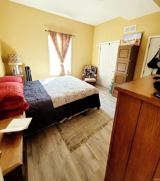 bedroom with visible vents and light wood-style flooring