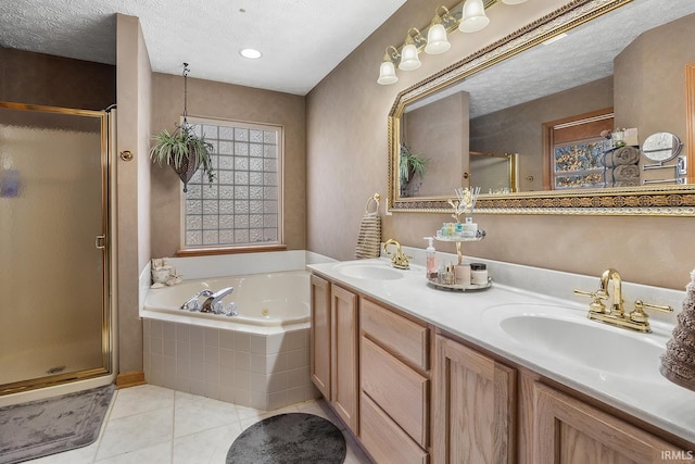 full bathroom featuring a stall shower, tile patterned flooring, a sink, and a tub with jets