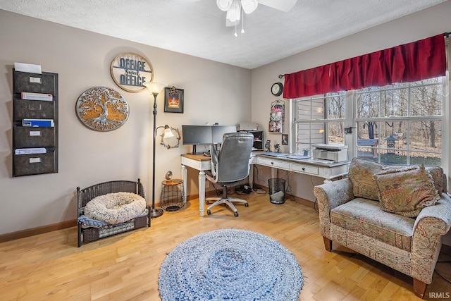 office area featuring ceiling fan, a textured ceiling, baseboards, and wood finished floors