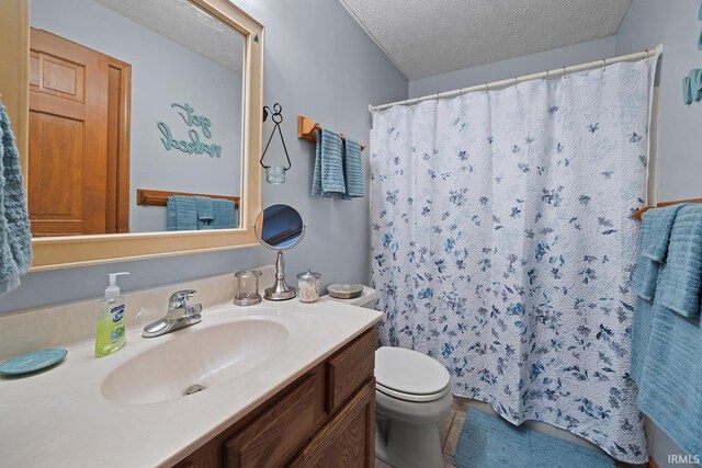 bathroom with a shower with shower curtain, a textured ceiling, toilet, and vanity