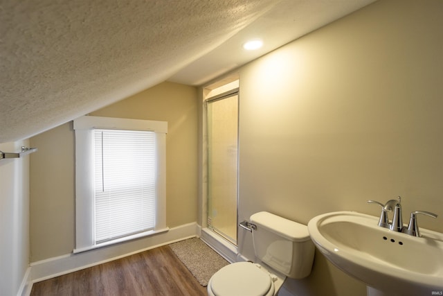 full bathroom featuring an enclosed shower, wood finished floors, a textured ceiling, and a sink