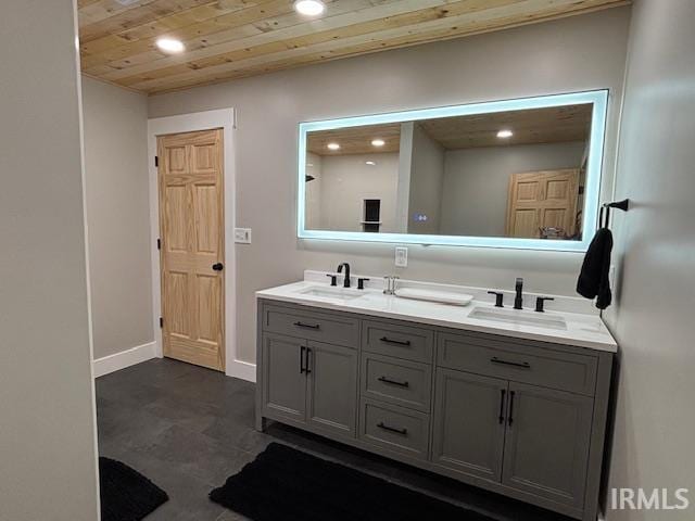 bathroom with a sink, double vanity, wooden ceiling, and recessed lighting