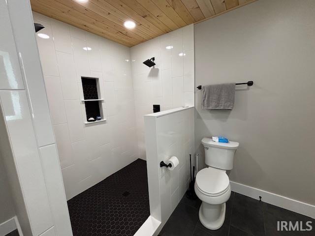 full bath featuring tile patterned floors, toilet, wooden ceiling, and a tile shower