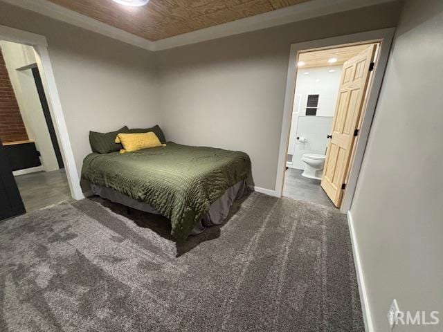 carpeted bedroom featuring ensuite bath, crown molding, and baseboards