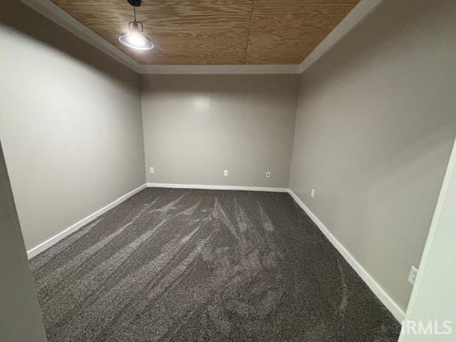 unfurnished room with dark carpet, baseboards, wood ceiling, and crown molding