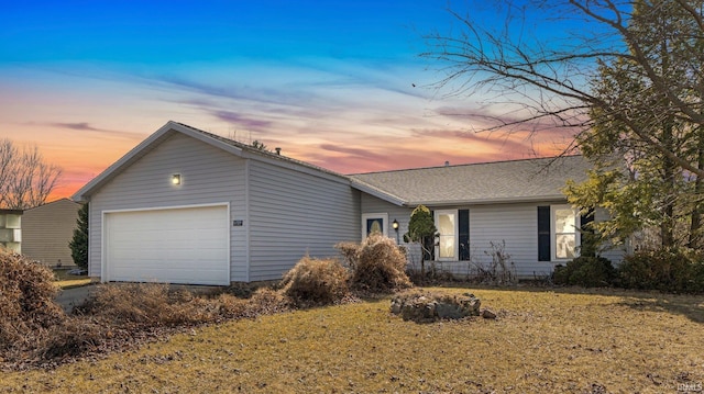 ranch-style home with an attached garage and roof with shingles