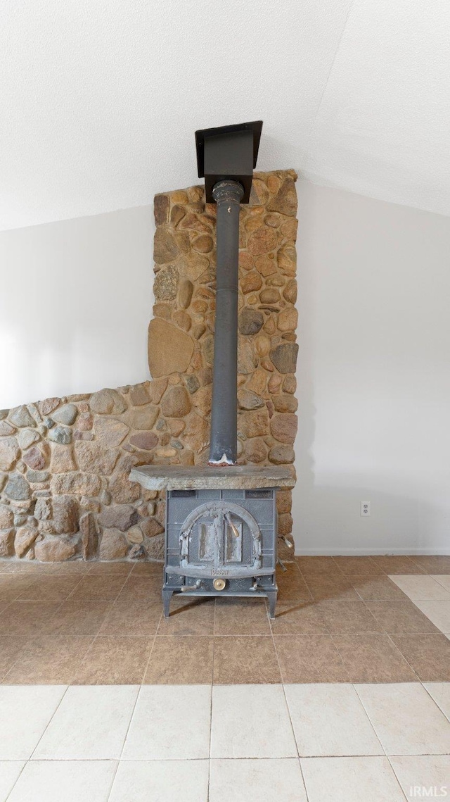 room details featuring a wood stove and a textured ceiling