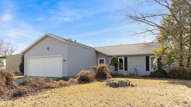 ranch-style home with a shingled roof and an attached garage