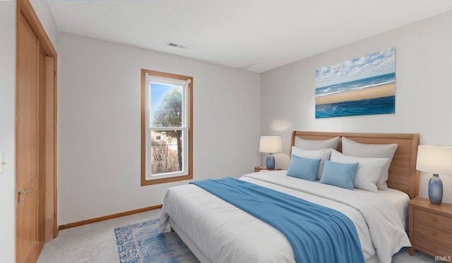 bedroom featuring baseboards, visible vents, and light colored carpet