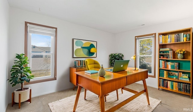 office featuring light carpet and baseboards