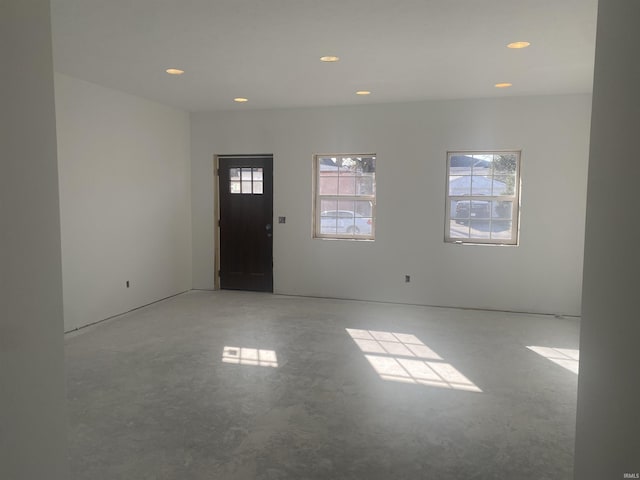 entrance foyer featuring a wealth of natural light, concrete floors, and recessed lighting