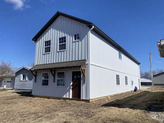 view of side of property with metal roof and board and batten siding