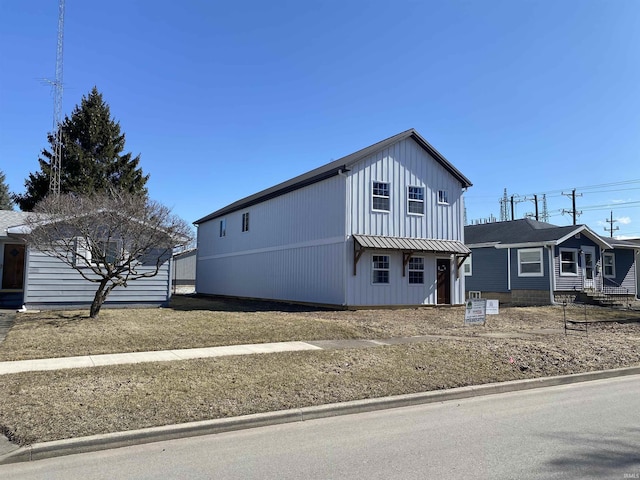 view of front of home featuring board and batten siding, a standing seam roof, and metal roof