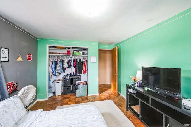 bedroom with baseboards and a closet