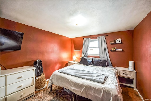 bedroom with wood finished floors and baseboards