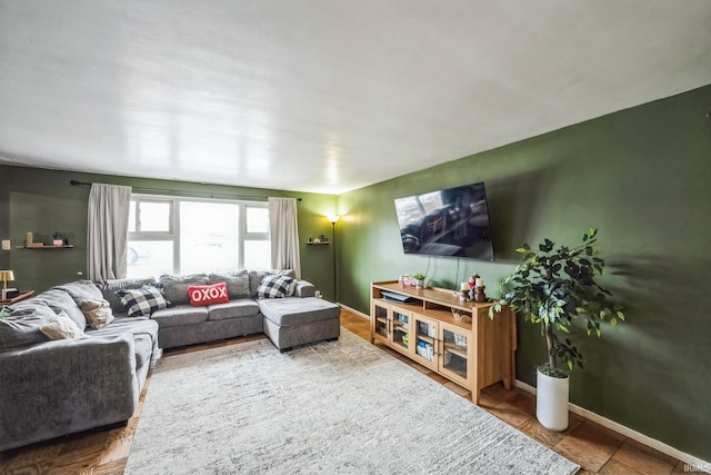 living area featuring baseboards