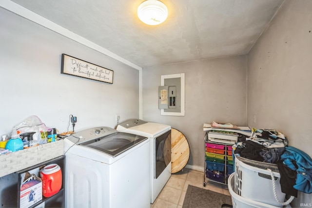 laundry area with laundry area, washing machine and dryer, electric panel, and light tile patterned flooring