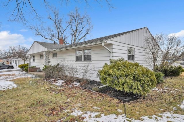 snow covered property with a chimney